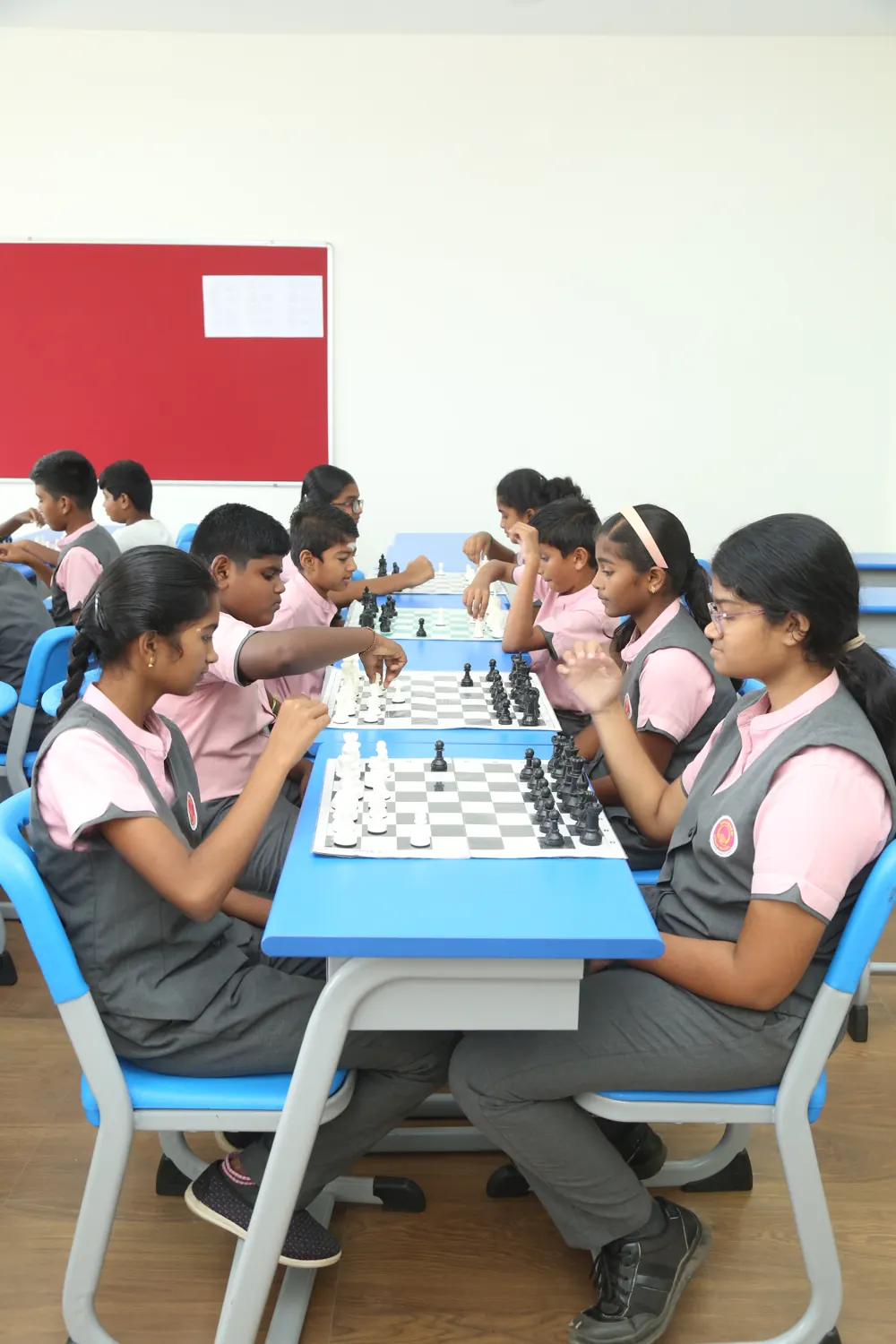 Students play chess at their desks