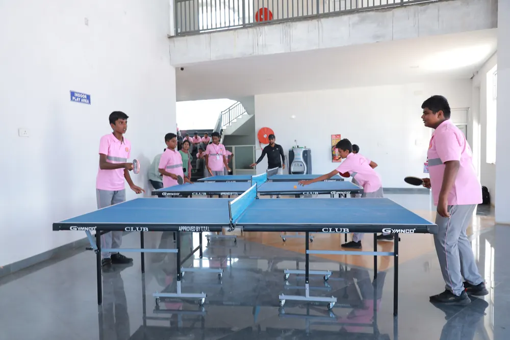 Students play table tennis in the indoor games hall
