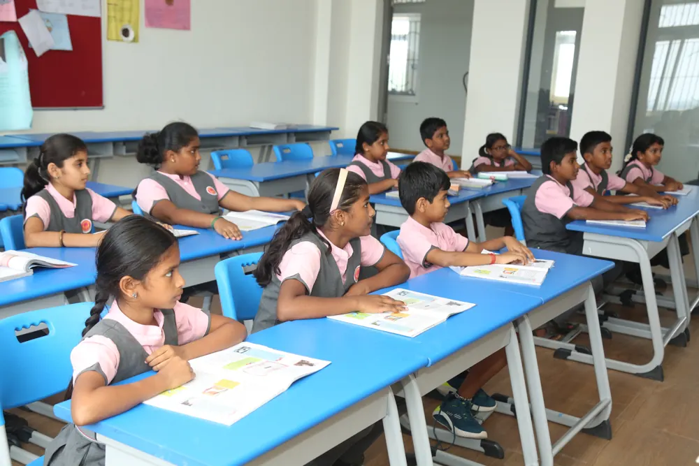 Students read at their desks in a bright classroom